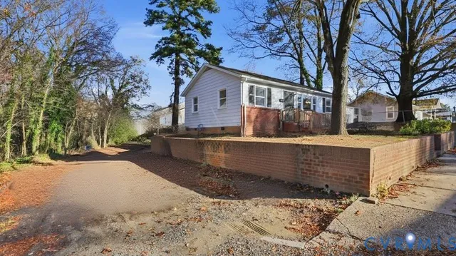 a view of a house with a yard covered in snow