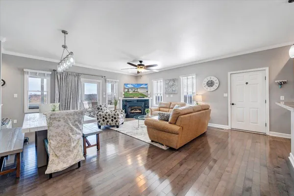 a living room with furniture a flat screen tv and a fireplace