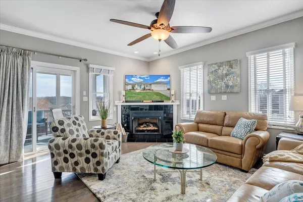 a living room with furniture a fireplace and a flat screen tv