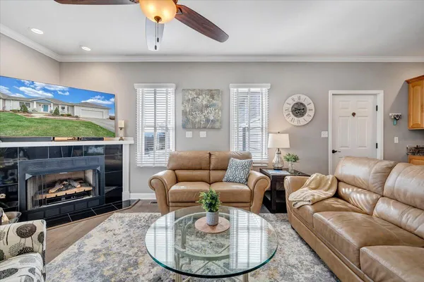 a living room with furniture and a wooden floor