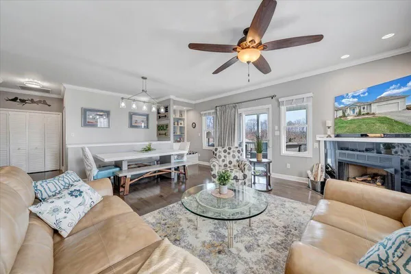 a living room with furniture and a floor to ceiling window