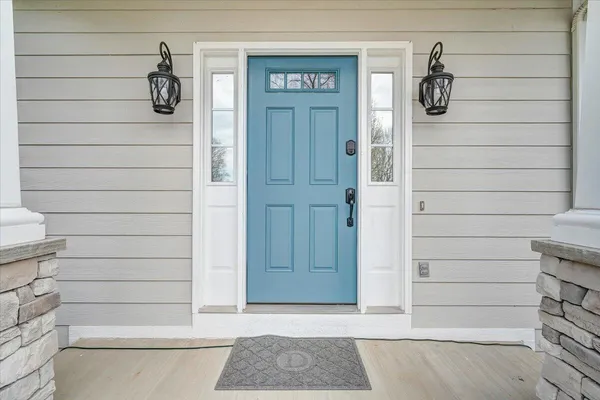 a kitchen with granite countertop a stove a sink and a wooden floors