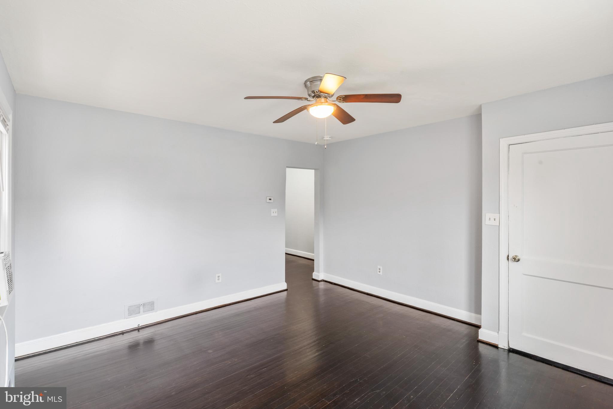 1209 Savannah Street Southeast Washington, DC 20032 - Photo 12 of 27 wooden floor in an empty room with a window