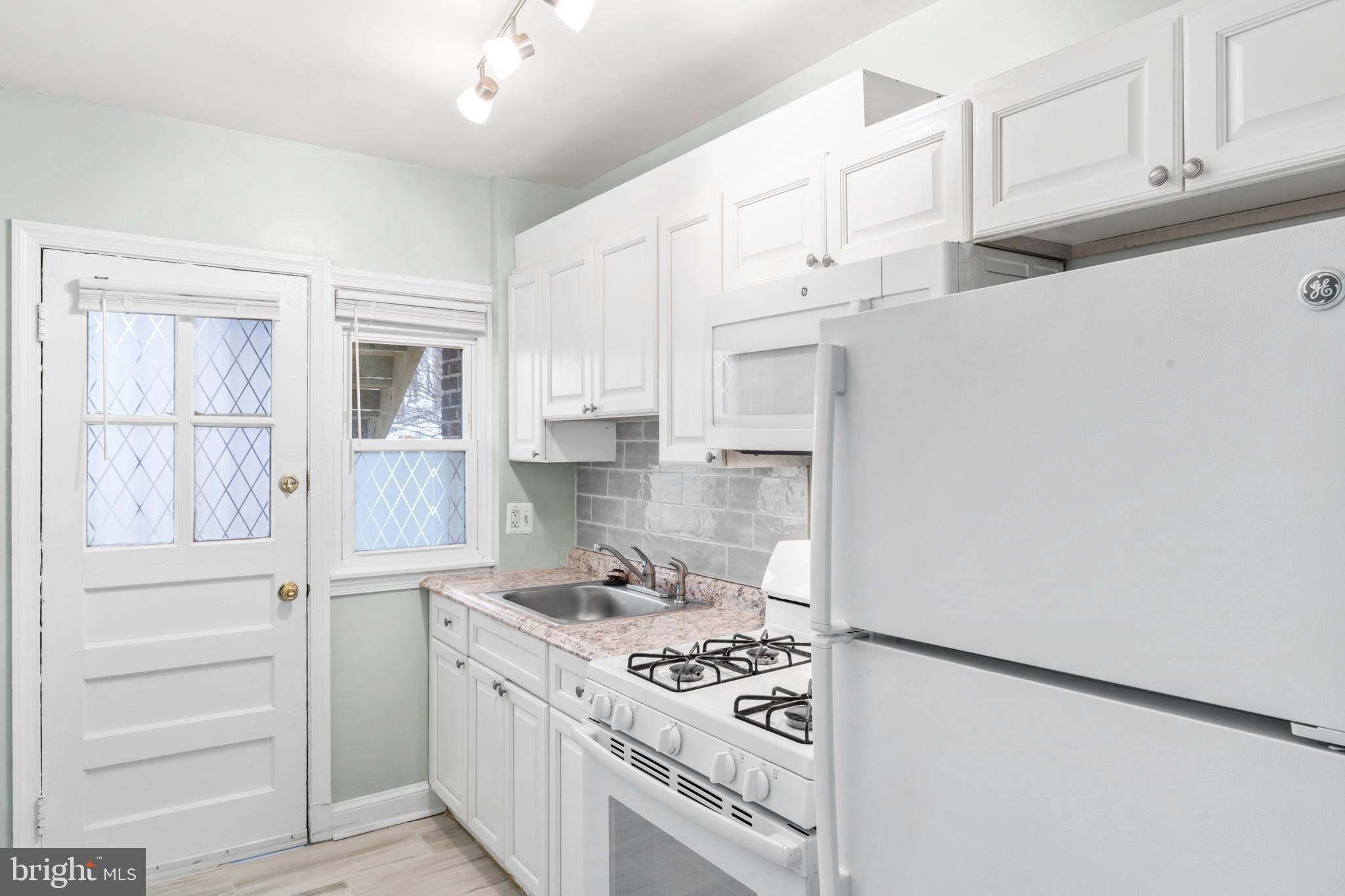 1209 Savannah Street Southeast Washington, DC 20032 - Photo 16 of 27 a kitchen with stainless steel appliances granite countertop a stove and a refrigerator