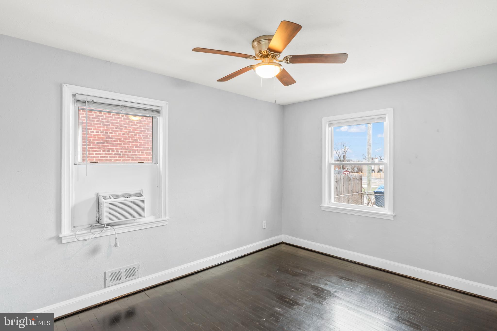 1209 Savannah Street Southeast Washington, DC 20032 - Photo 17 of 27 a view of an empty room with wooden floor and a window