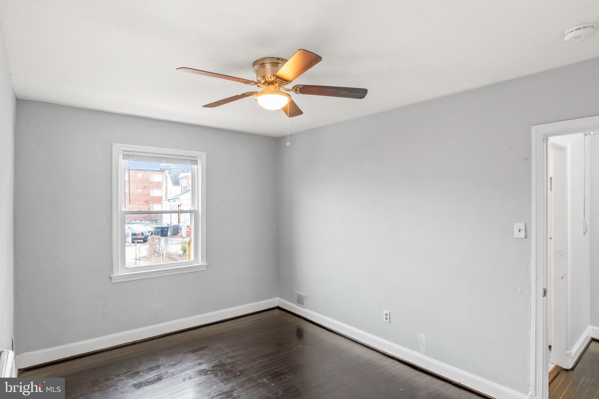 1209 Savannah Street Southeast Washington, DC 20032 - Photo 19 of 27 an empty room with windows and fan