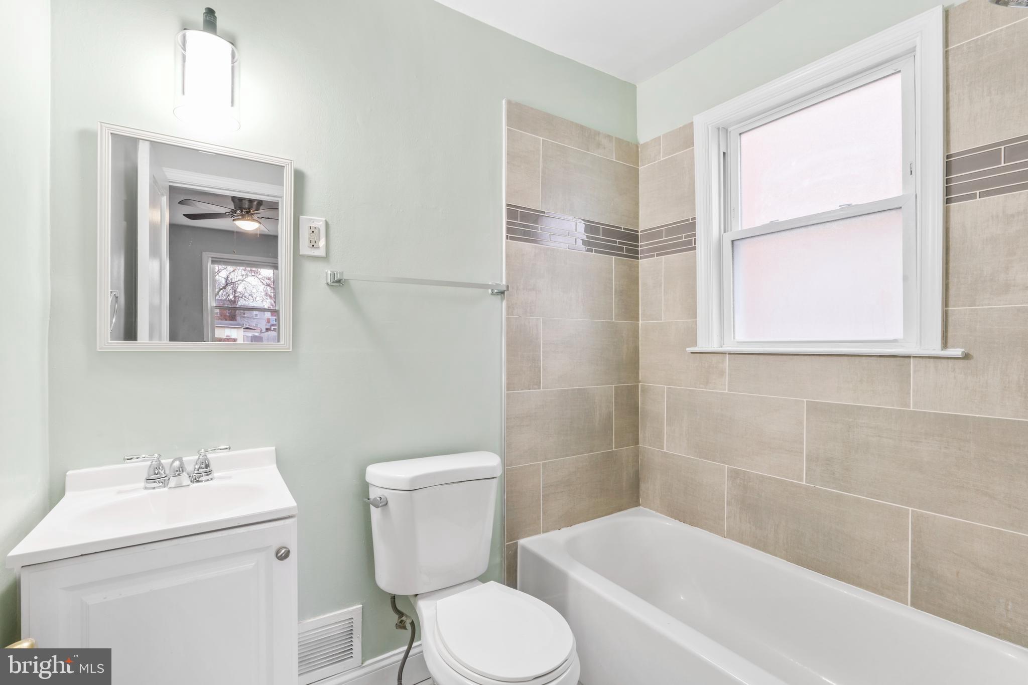 1209 Savannah Street Southeast Washington, DC 20032 - Photo 20 of 27 a white toilet sitting next to a bath tub