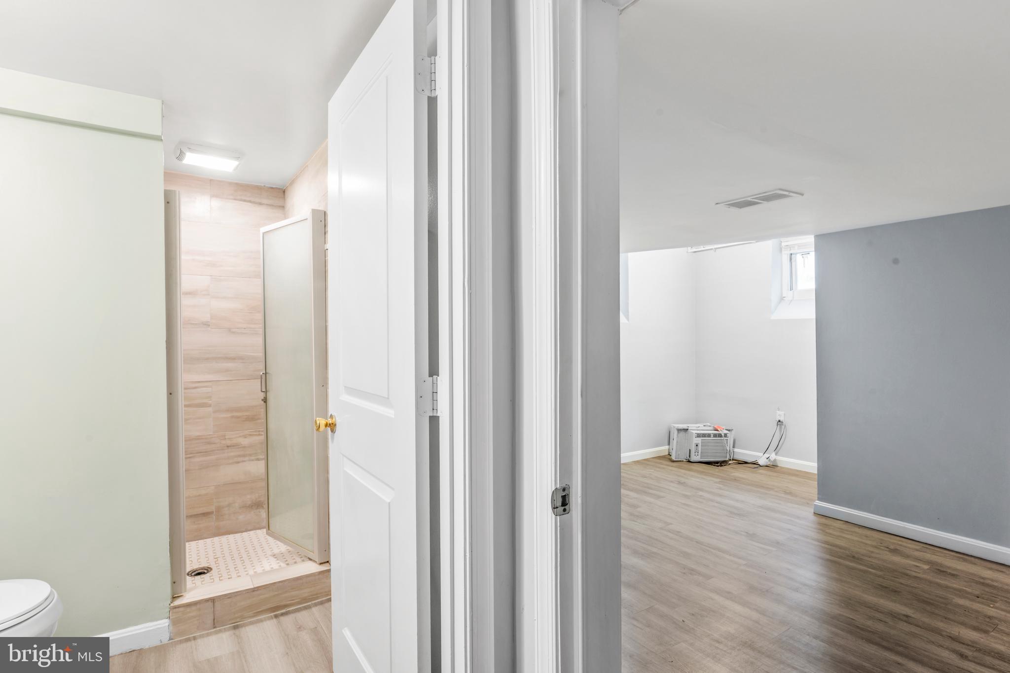 1209 Savannah Street Southeast Washington, DC 20032 - Photo 24 of 27 a bathroom with a glass shower door
