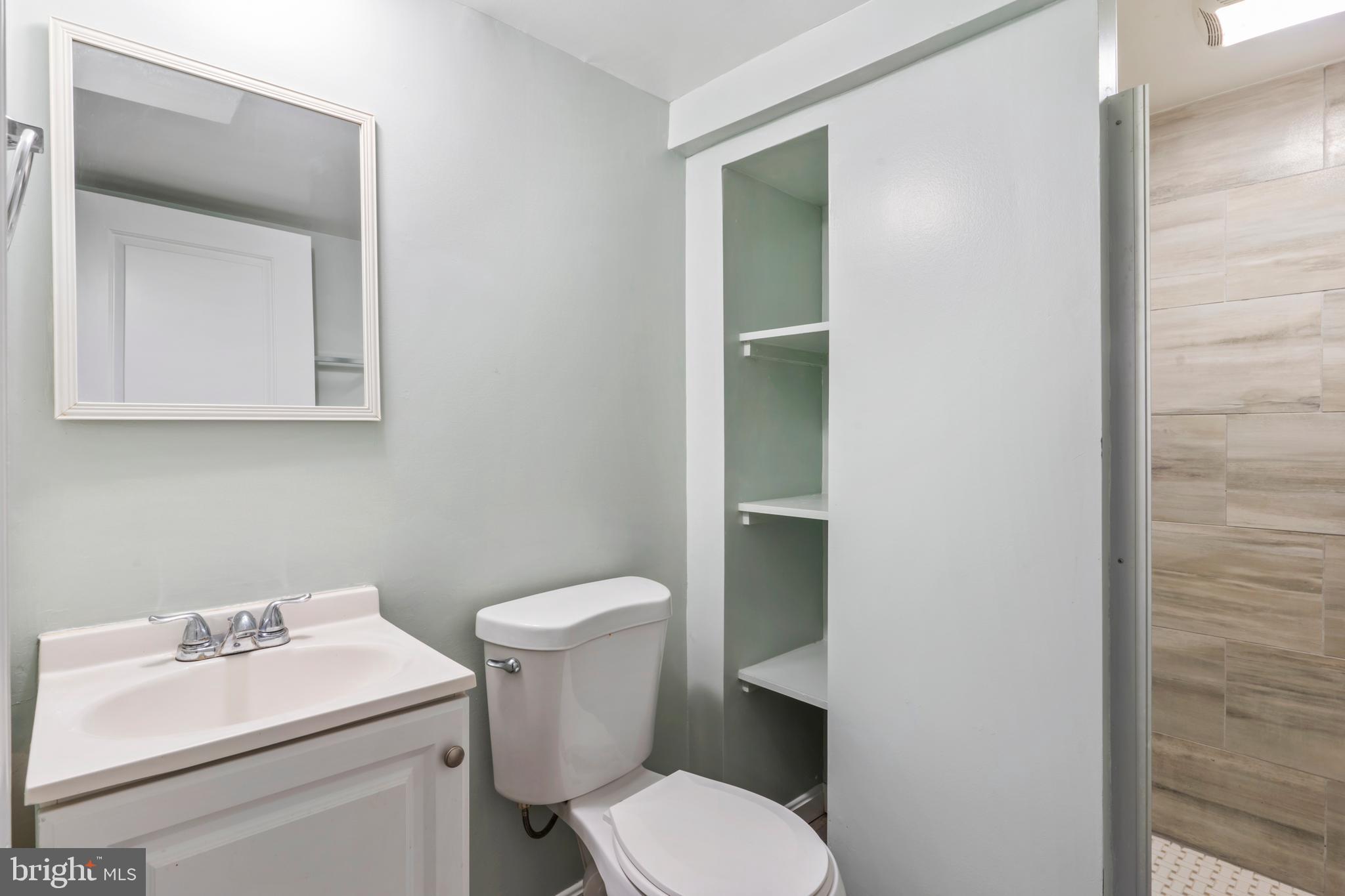 1209 Savannah Street Southeast Washington, DC 20032 - Photo 25 of 27 a bathroom with a toilet sink and mirror