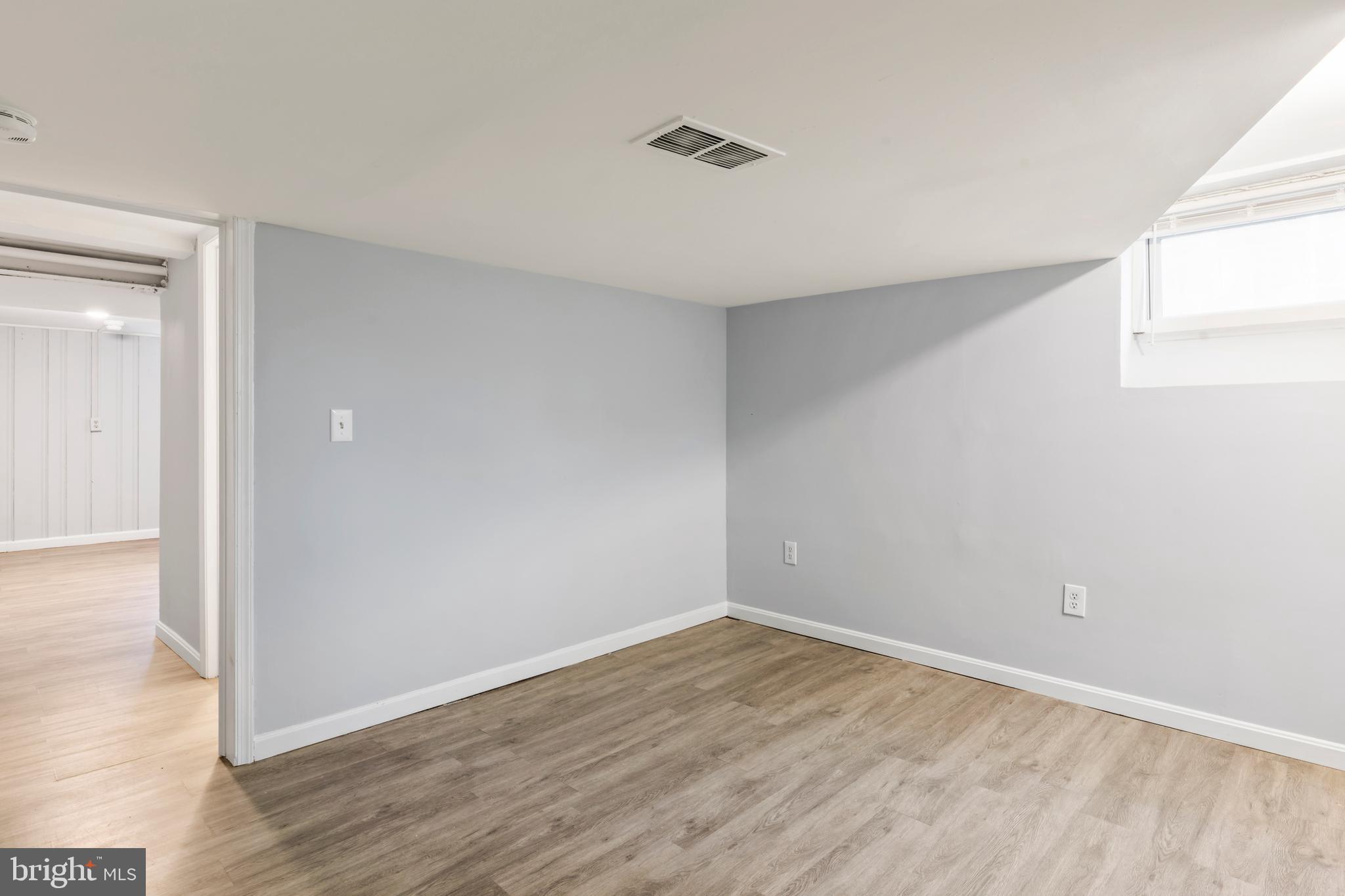 1209 Savannah Street Southeast Washington, DC 20032 - Photo 27 of 27 a view of an empty room with wooden floor and a window
