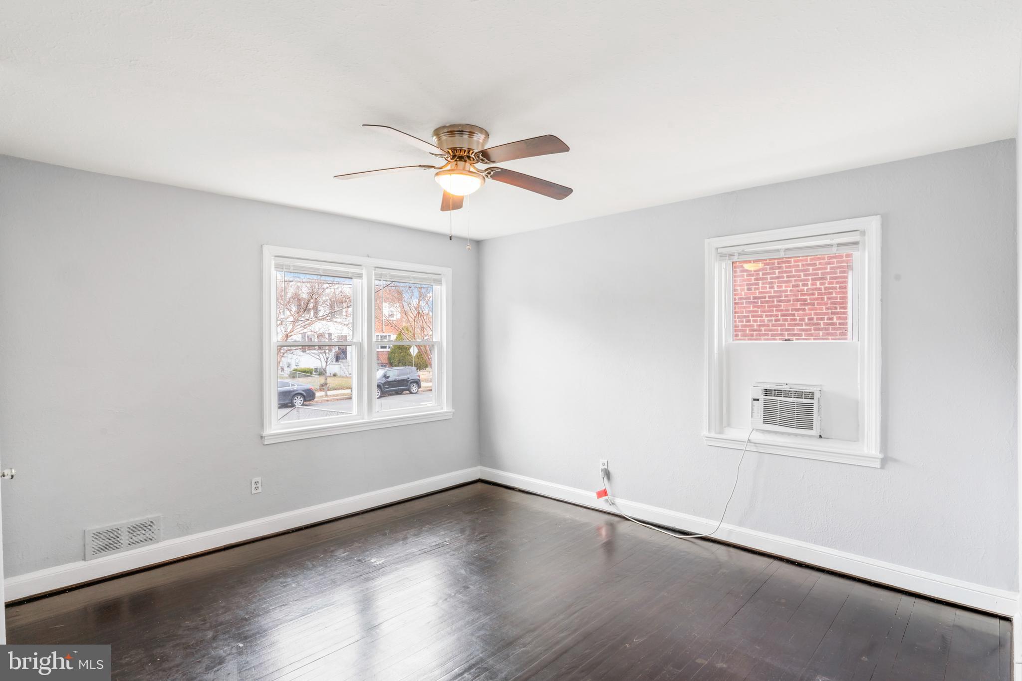 1209 Savannah Street Southeast Washington, DC 20032 - Photo 8 of 27 a view of an empty room with a window and wooden floor