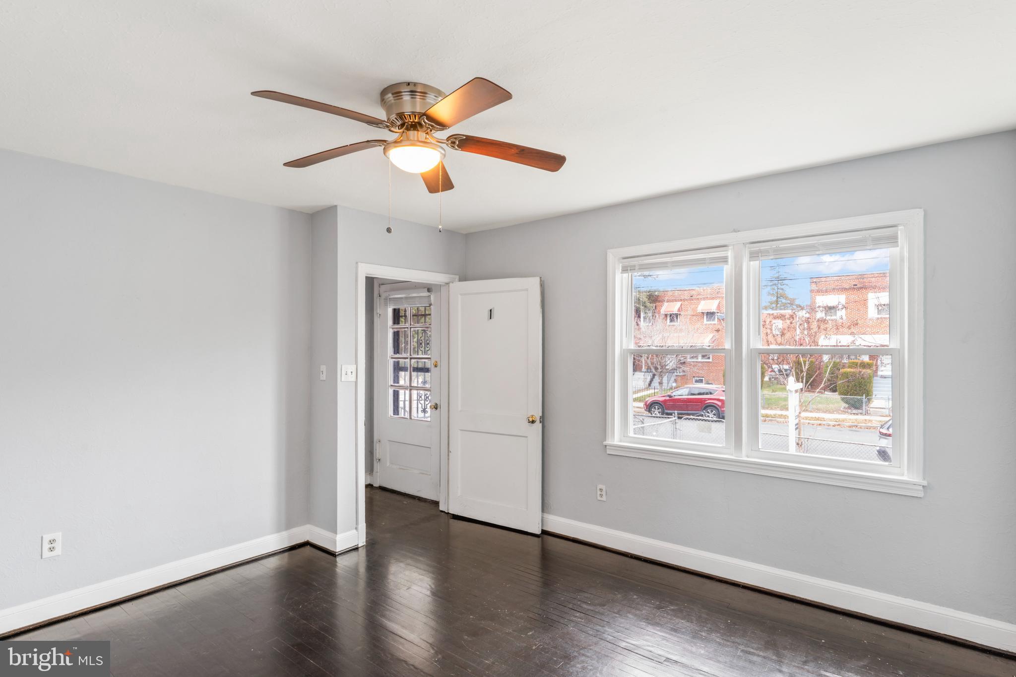 1209 Savannah Street Southeast Washington, DC 20032 - Photo 10 of 27 a view of an empty room with wooden floor and a window