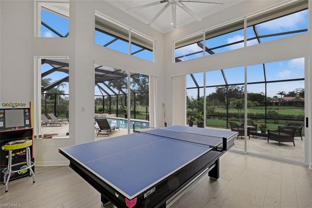 a room with pool table and windows