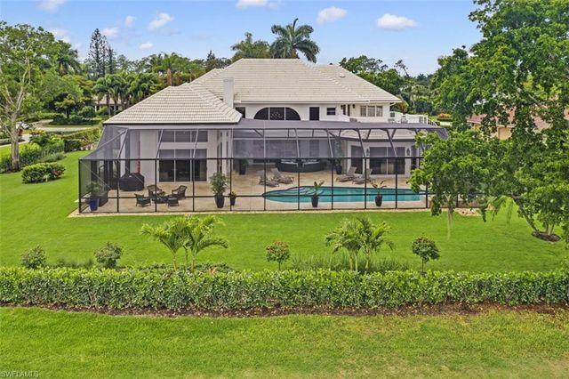 a aerial view of a house with swimming pool and garden