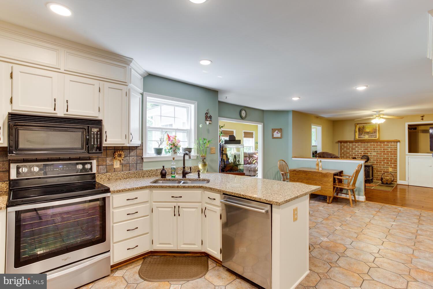6029 Hillside Road St. Leonard, MD 20685 - Photo 5 of 15 a kitchen with appliances cabinets and furniture