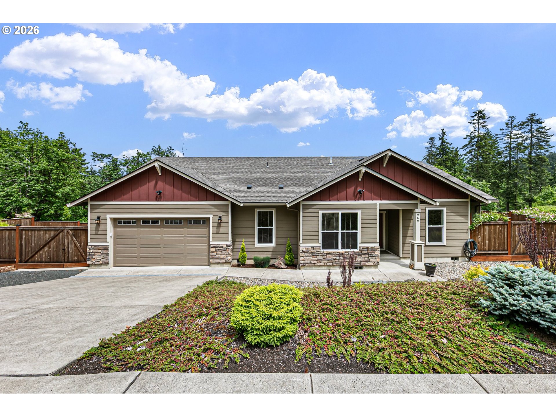 a front view of house with yard and trees in the background
