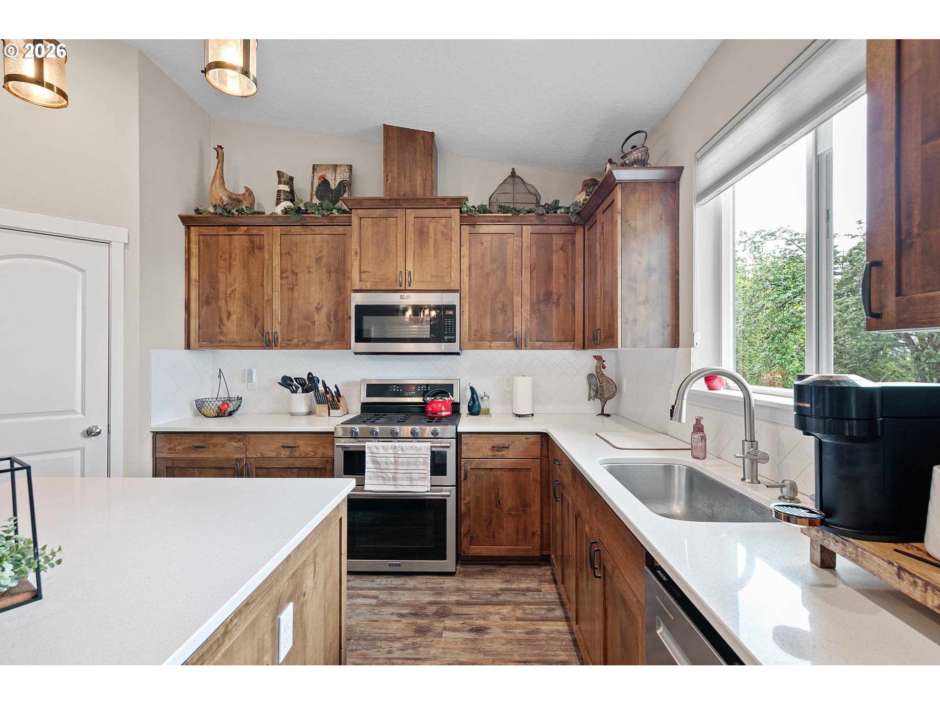 962 South 66th Place Springfield, OR 97478 - Photo 11 of 44 a kitchen with a sink a stove and cabinets