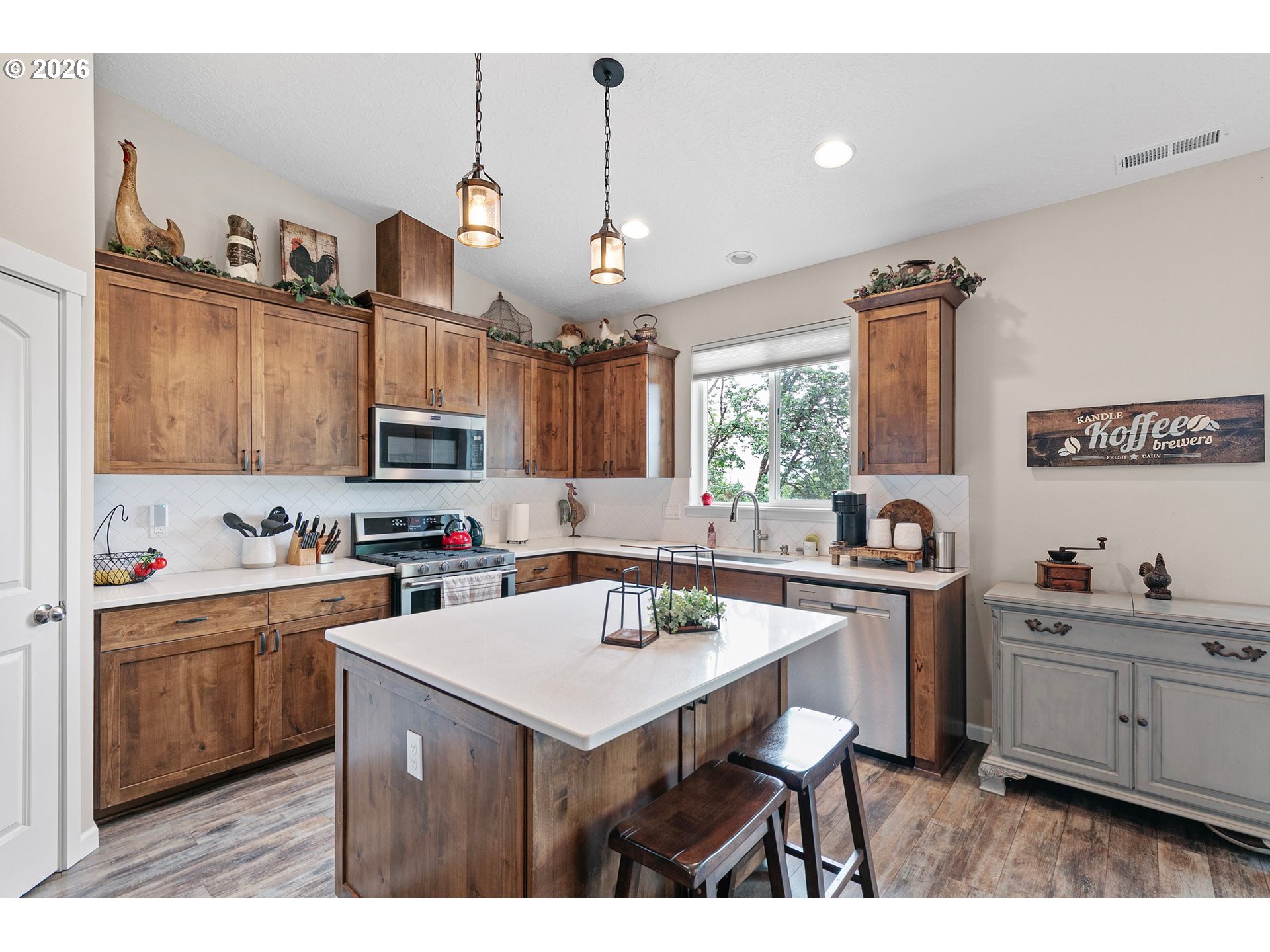 962 South 66th Place Springfield, OR 97478 - Photo 12 of 44 a kitchen with granite countertop a sink cabinets and window