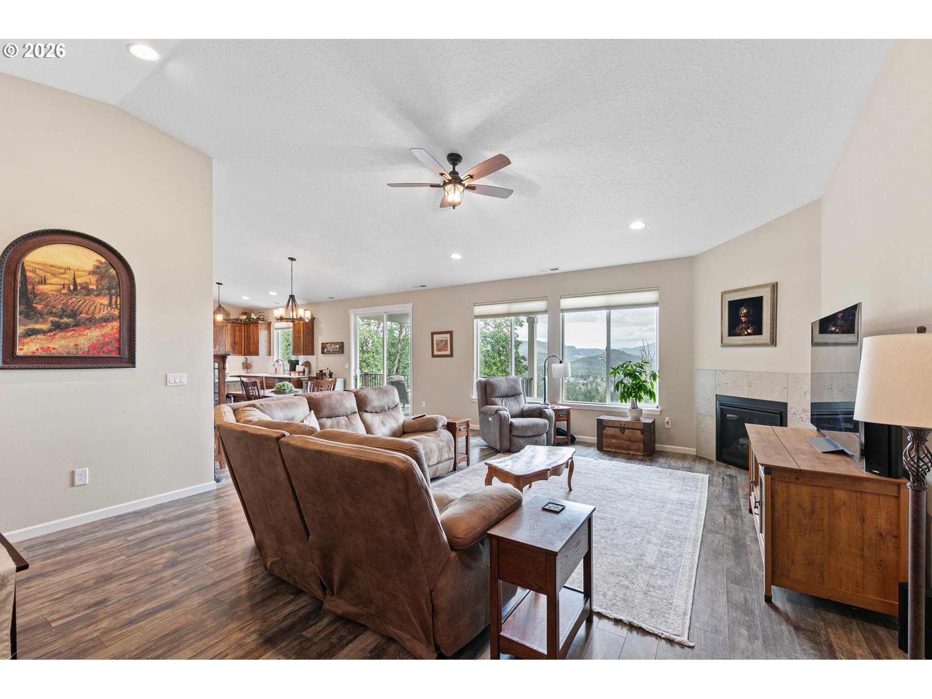 962 South 66th Place Springfield, OR 97478 - Photo 3 of 44 a living room with furniture a fireplace and a flat screen tv