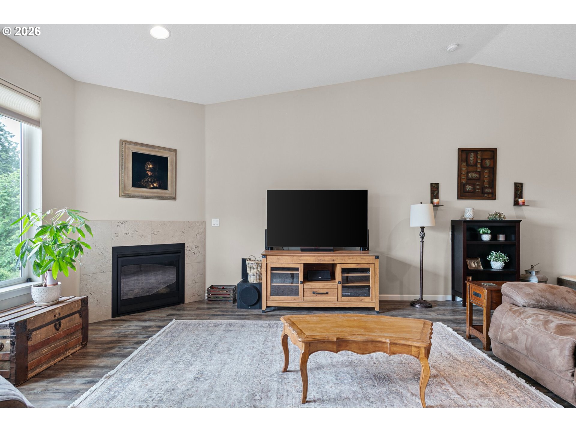 962 South 66th Place Springfield, OR 97478 - Photo 7 of 44 a living room with furniture a flat screen tv and a fireplace