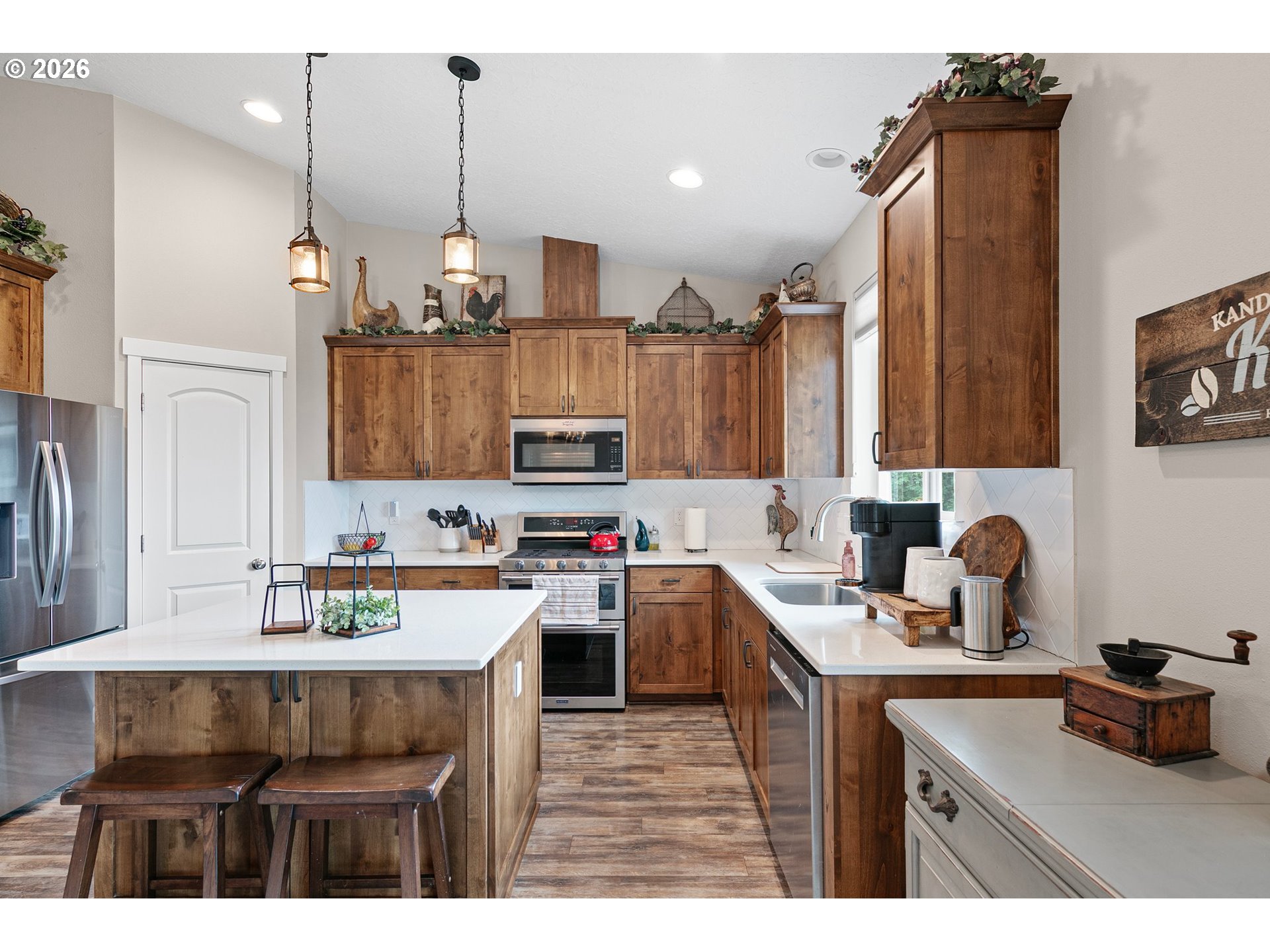 962 South 66th Place Springfield, OR 97478 - Photo 10 of 44 a kitchen with kitchen island a sink stove and microwave