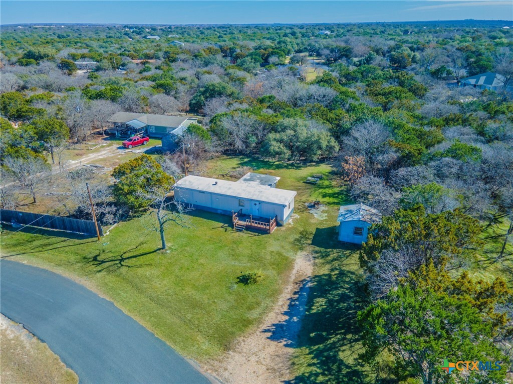 an aerial view of a house with a yard