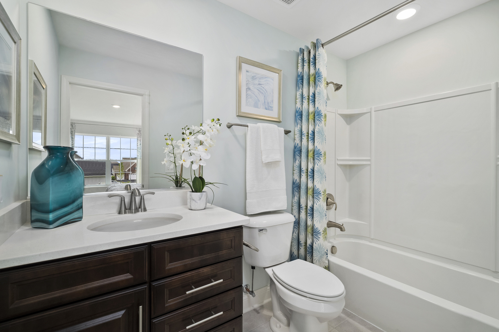 3675 Edelweiss Road Elgin, IL 60124 - Photo 28 of 38 a bathroom with a sink a toilet a mirror and shower