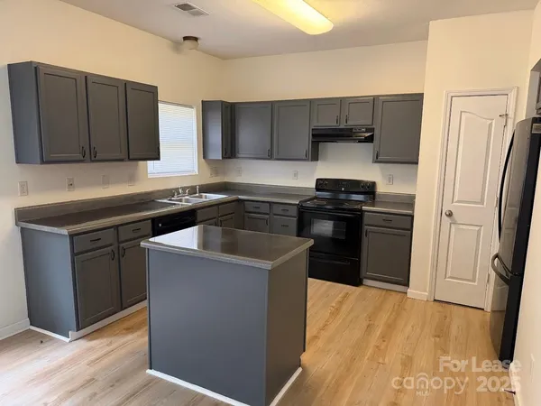 a kitchen with a sink a stove and refrigerator