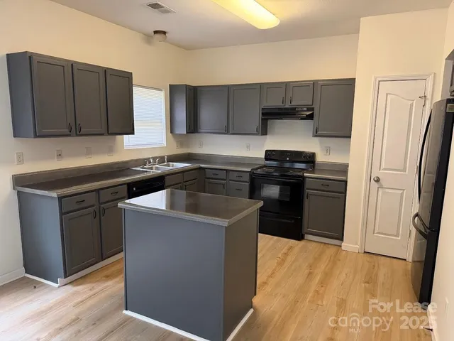 a kitchen with a sink a stove and refrigerator