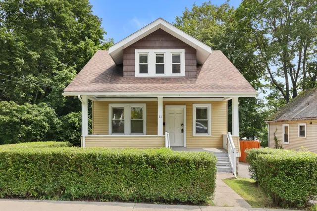 a front view of a house with garden