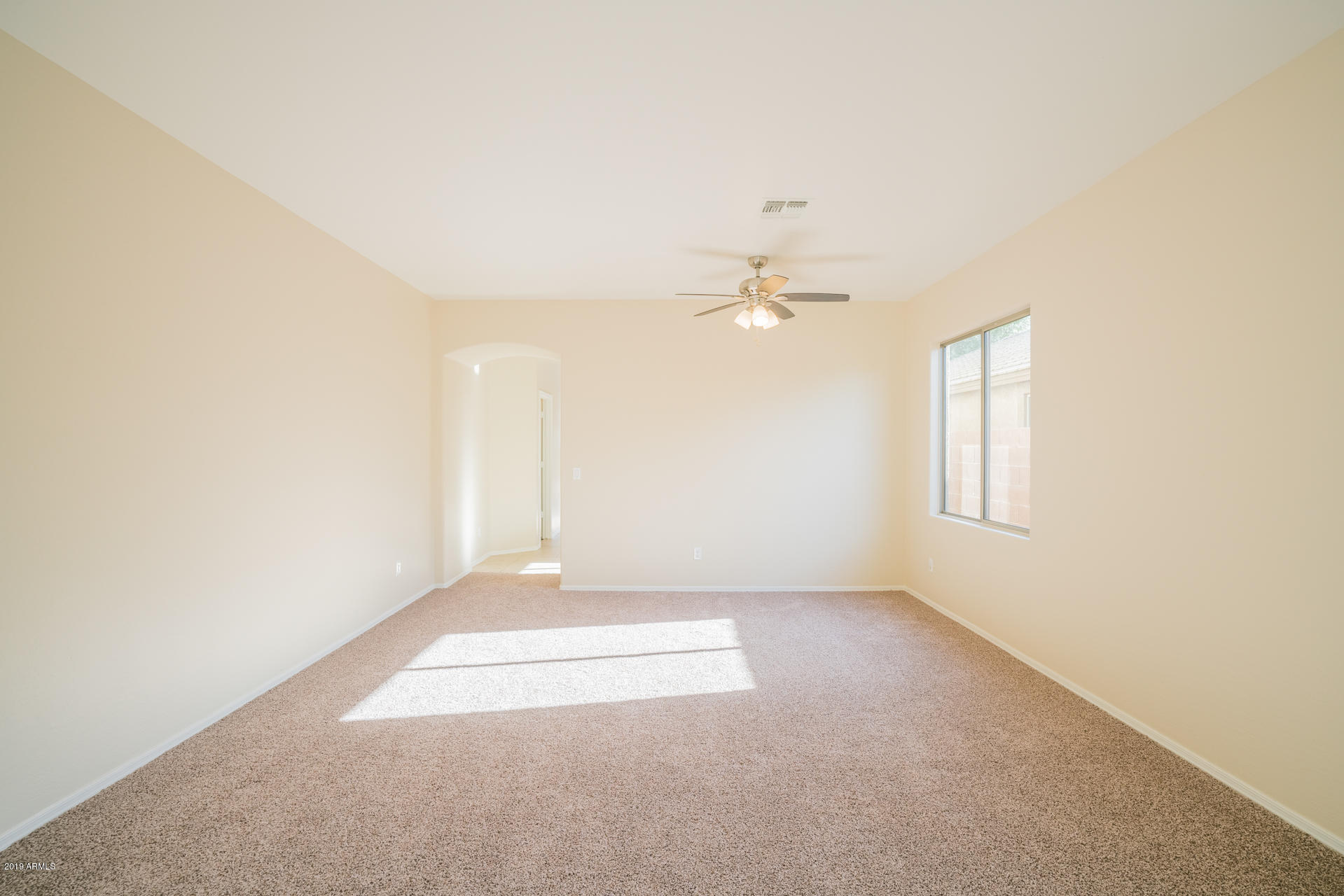 15441 West Shangri La Road Surprise, AZ 85379 - Photo 11 of 24 an empty room with windows and fan