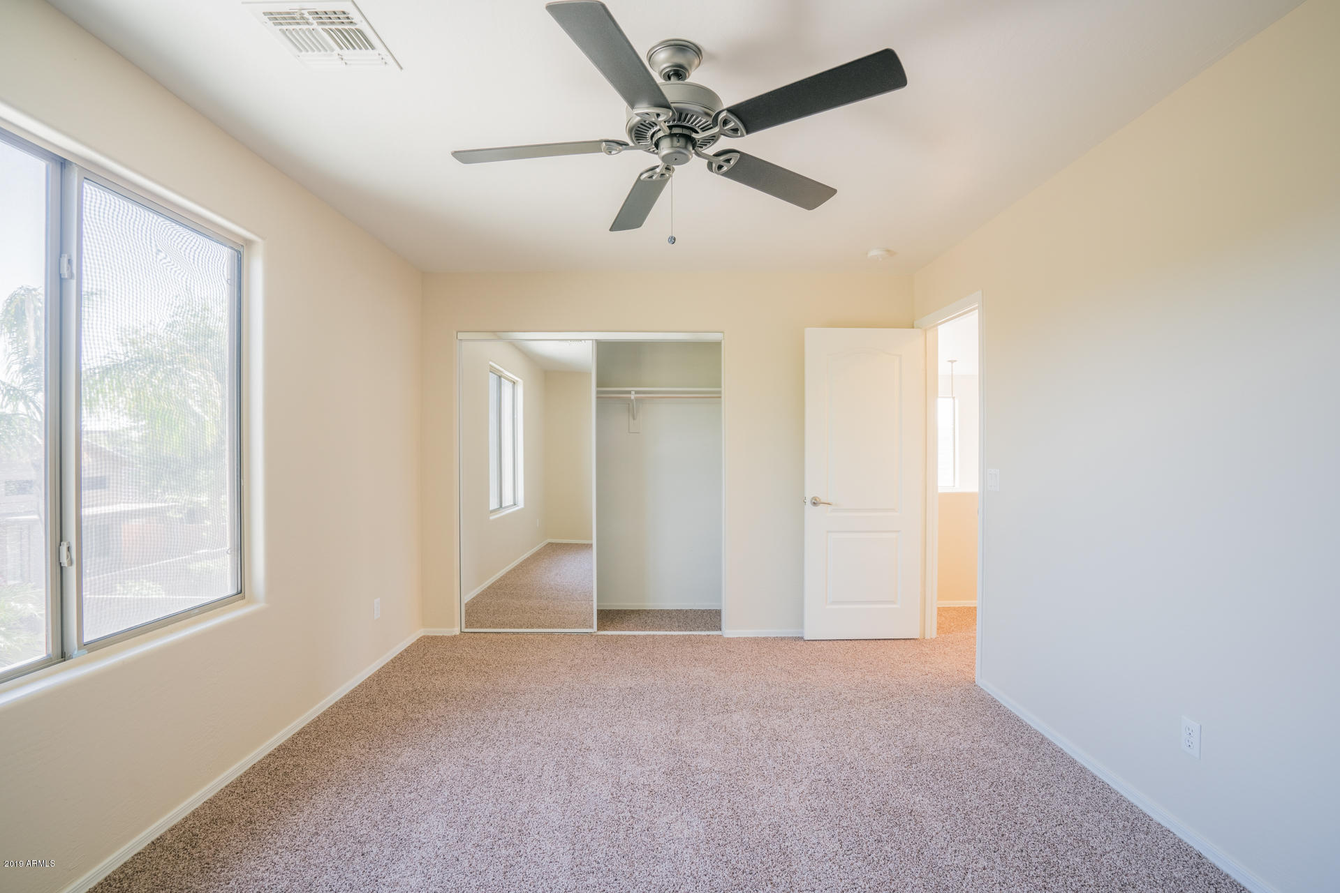 15441 West Shangri La Road Surprise, AZ 85379 - Photo 21 of 24 a view of a livingroom with a ceiling fan and window