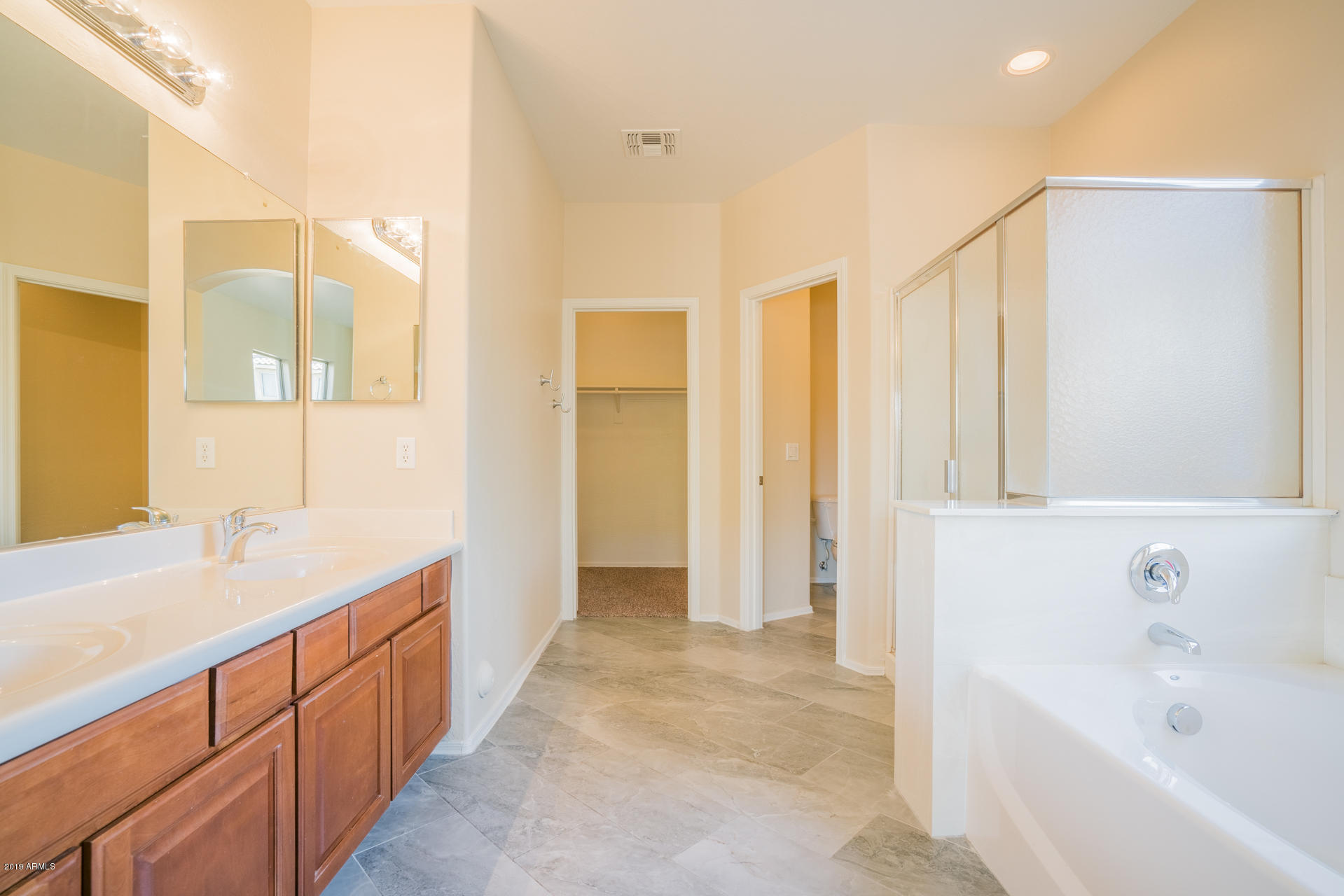 15441 West Shangri La Road Surprise, AZ 85379 - Photo 4 of 24 a spacious bathroom with a bathtub sink and mirror