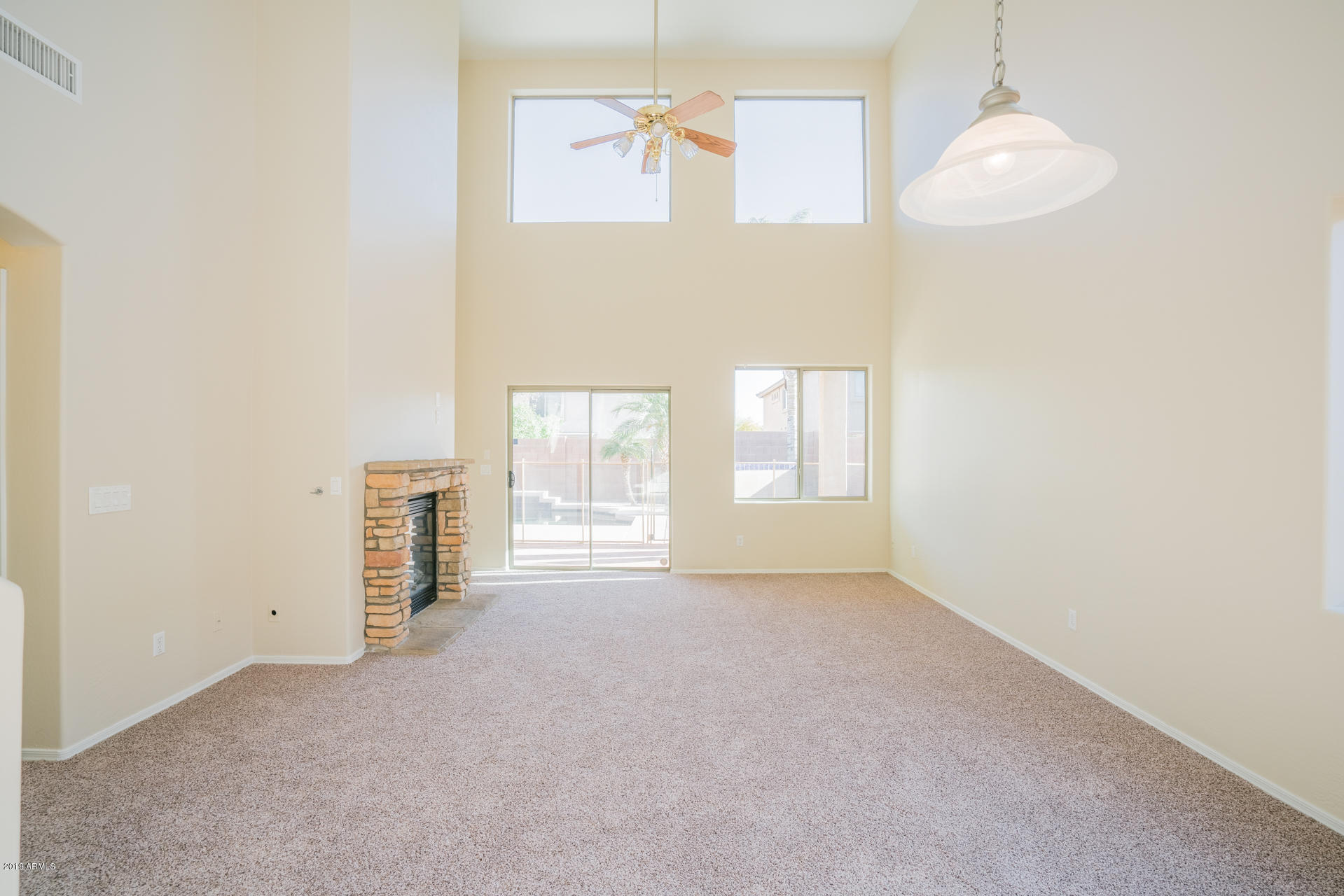 15441 West Shangri La Road Surprise, AZ 85379 - Photo 8 of 24 an empty room with windows and fireplace