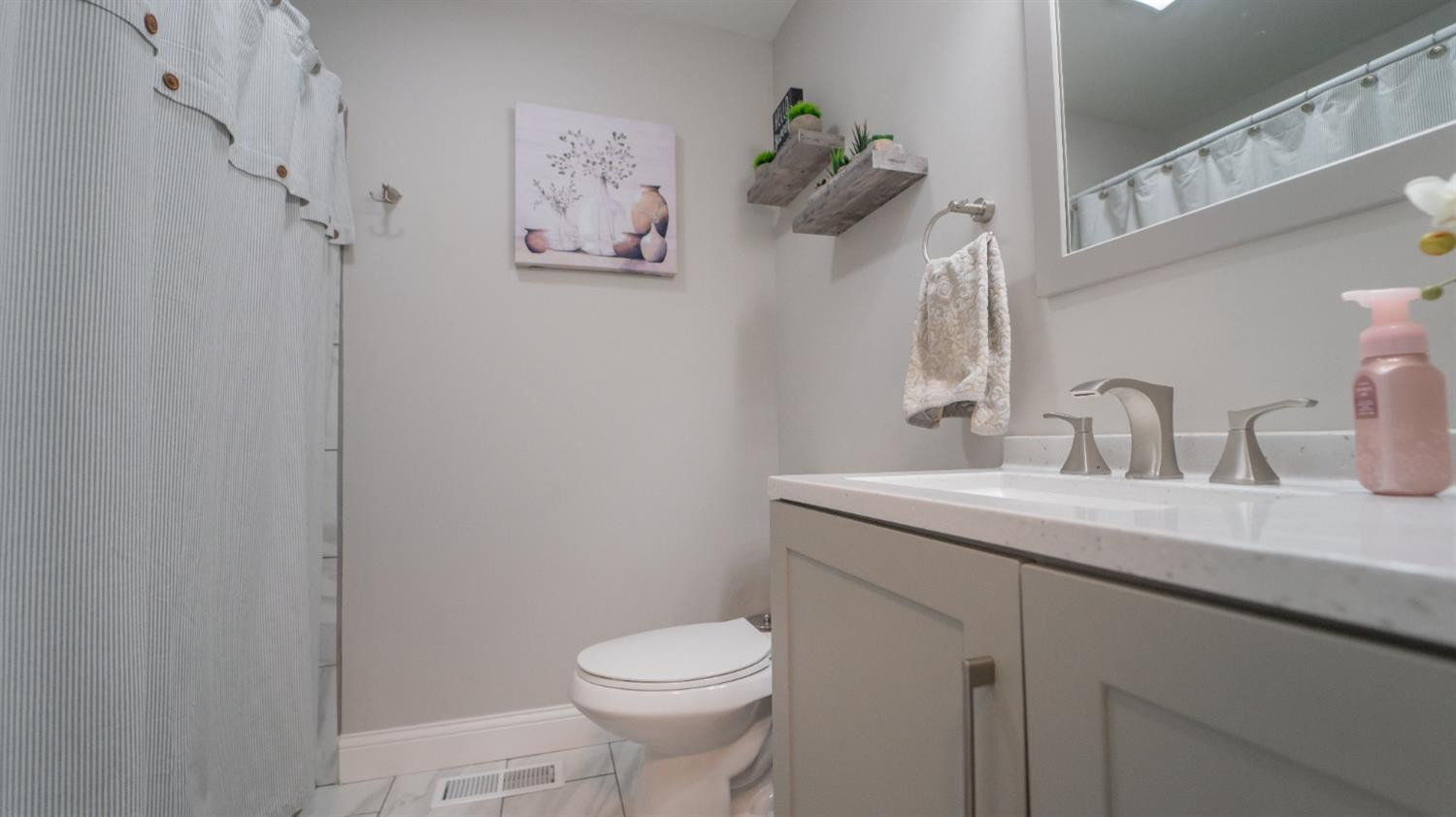 2225 Coldspring Road Crown Point, IN 46307 - Photo 16 of 22 a bathroom with a granite countertop sink mirror and toilet