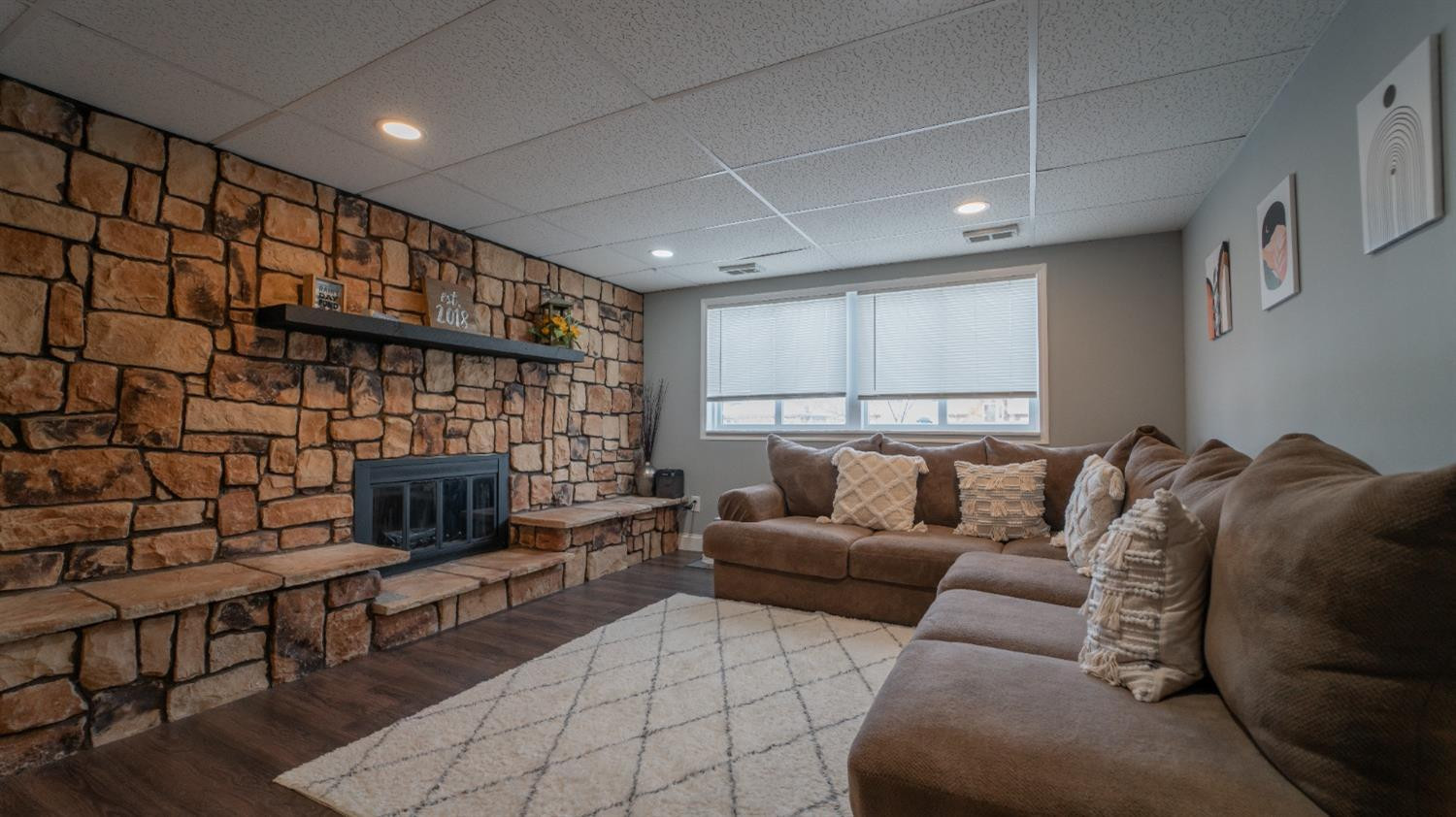 2225 Coldspring Road Crown Point, IN 46307 - Photo 18 of 22 a living room with furniture a flat screen tv and a fireplace