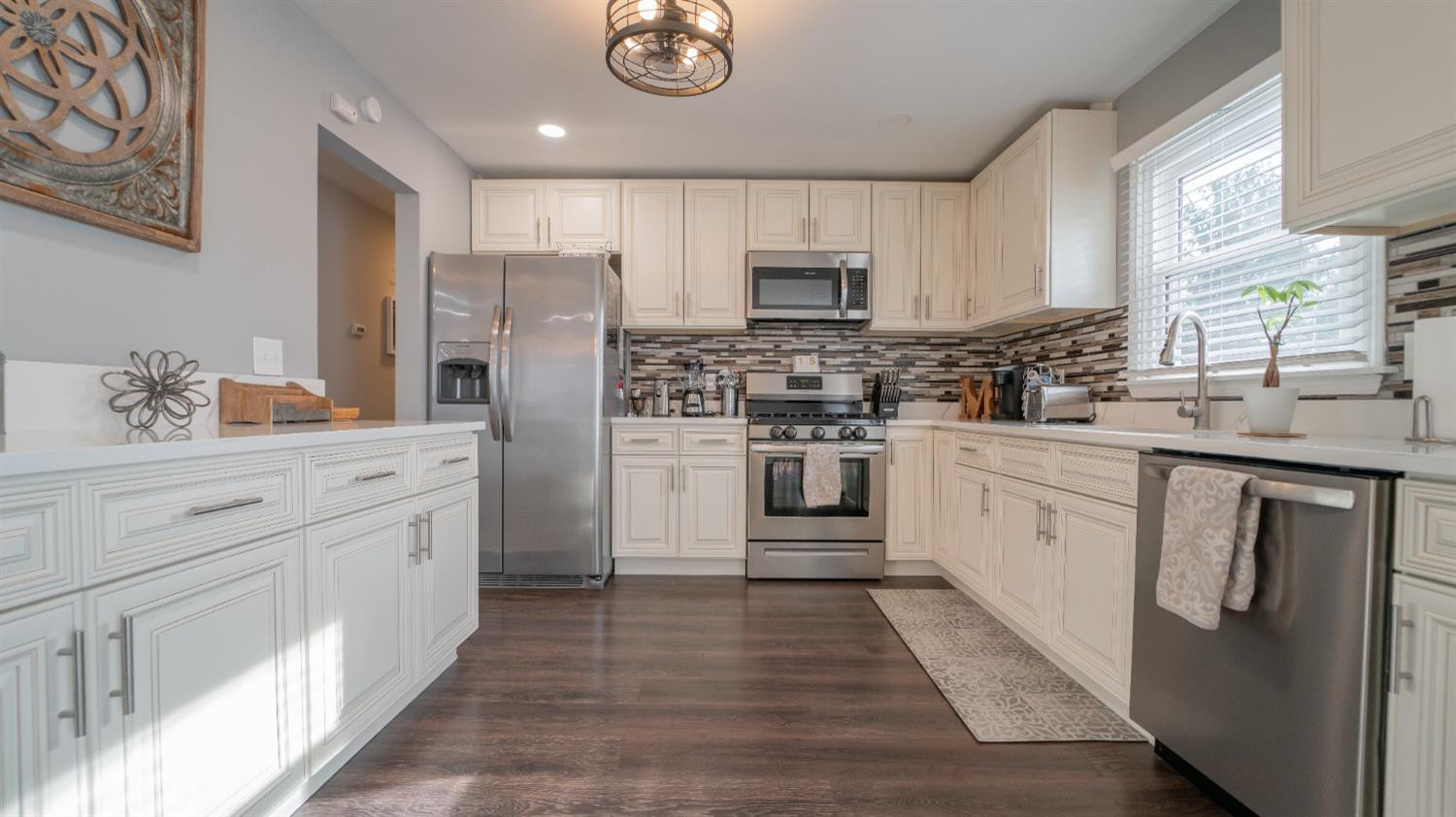 2225 Coldspring Road Crown Point, IN 46307 - Photo 5 of 22 a kitchen with stainless steel appliances granite countertop a refrigerator a sink dishwasher a stove with wooden cabinets and floor