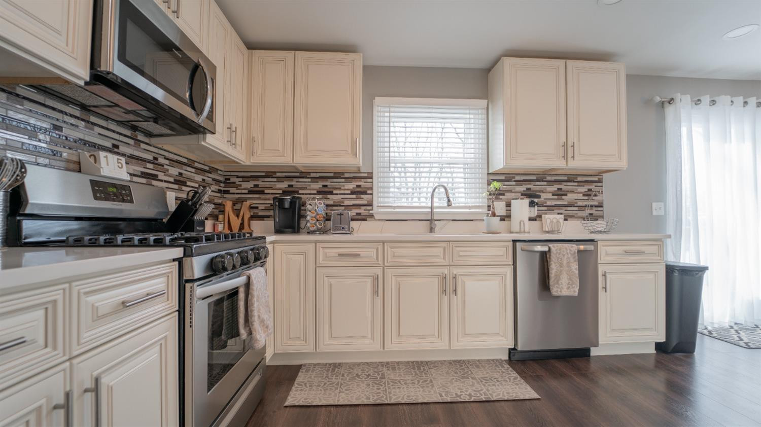 2225 Coldspring Road Crown Point, IN 46307 - Photo 6 of 22 a kitchen with stainless steel appliances granite countertop a stove a sink and a microwave