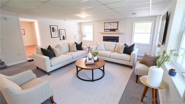 a living room with furniture potted plant and a window