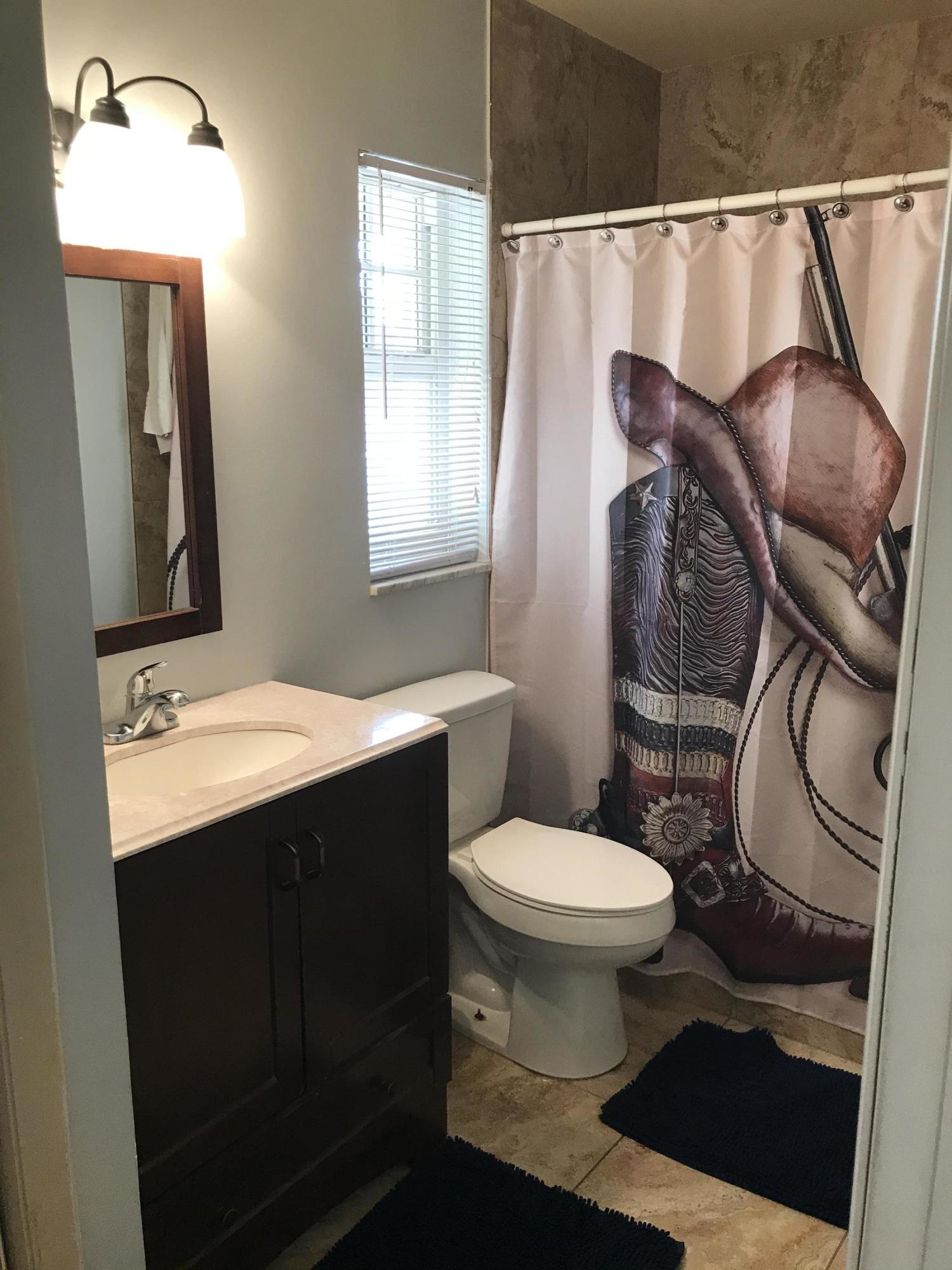 680 Southwest 17th Court Boca Raton, FL 33486 - Photo 15 of 27 a bathroom with a sink toilet and mirror