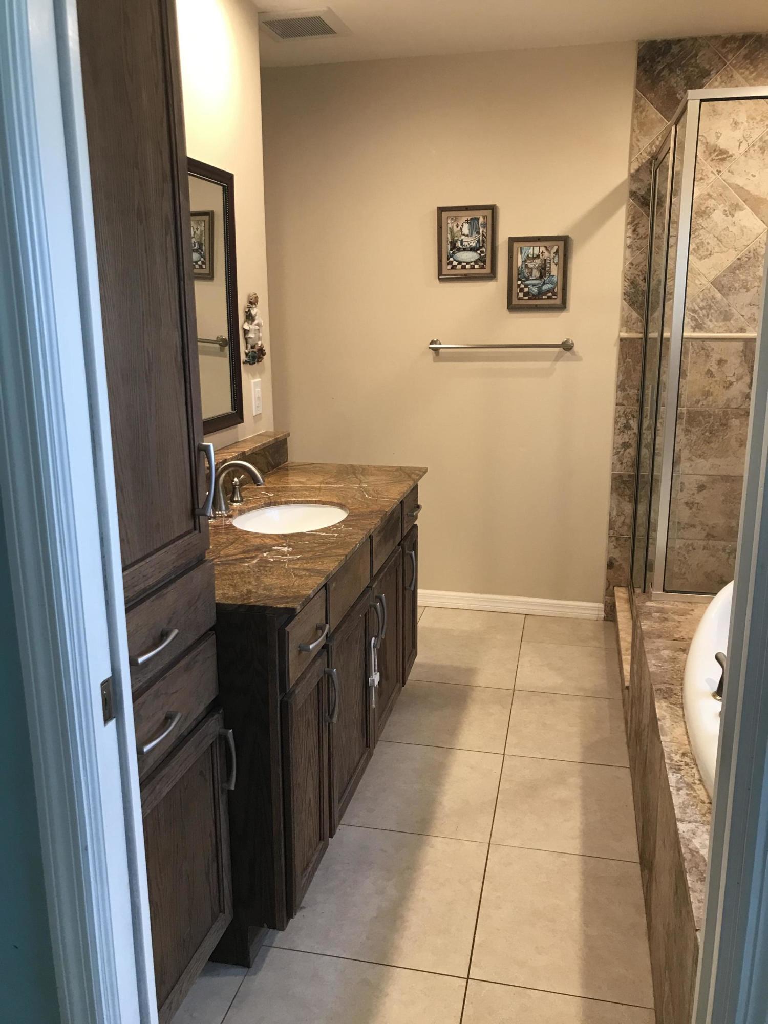 680 Southwest 17th Court Boca Raton, FL 33486 - Photo 24 of 27 a bathroom with a sink a toilet and a mirror