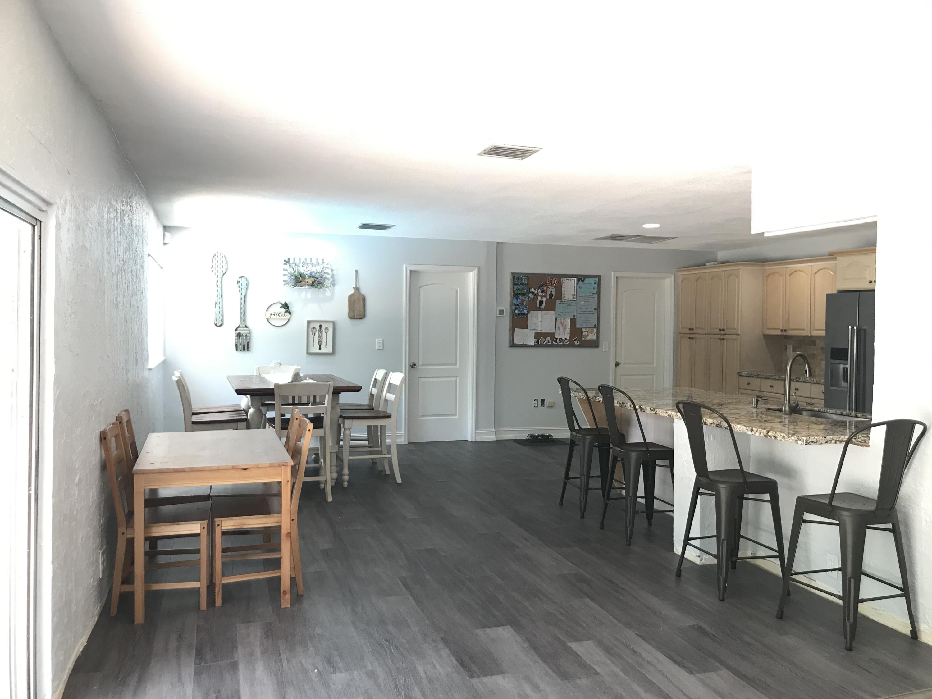 680 Southwest 17th Court Boca Raton, FL 33486 - Photo 6 of 27 a view of a dining room with furniture and wooden floor