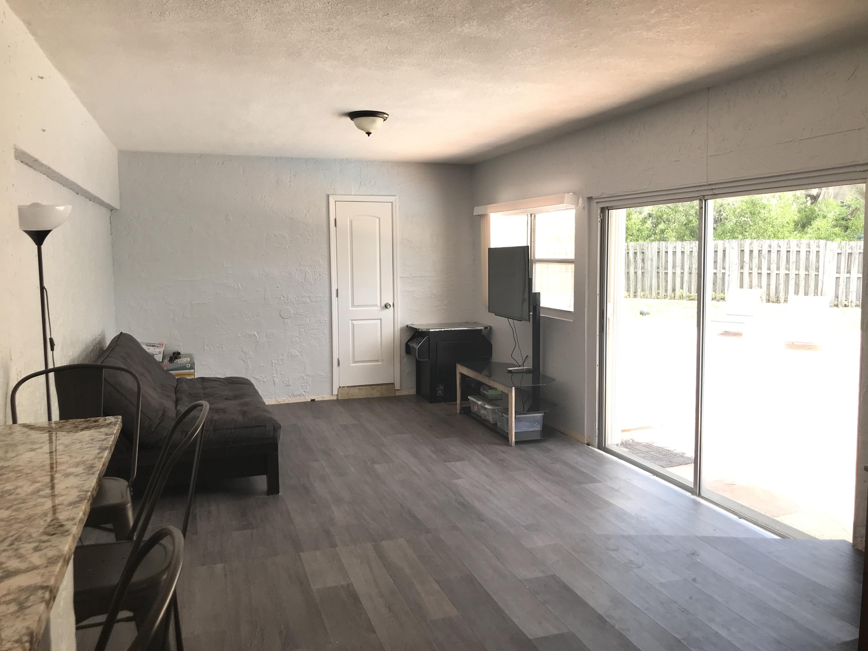 680 Southwest 17th Court Boca Raton, FL 33486 - Photo 7 of 27 a living room with furniture and a floor to ceiling window