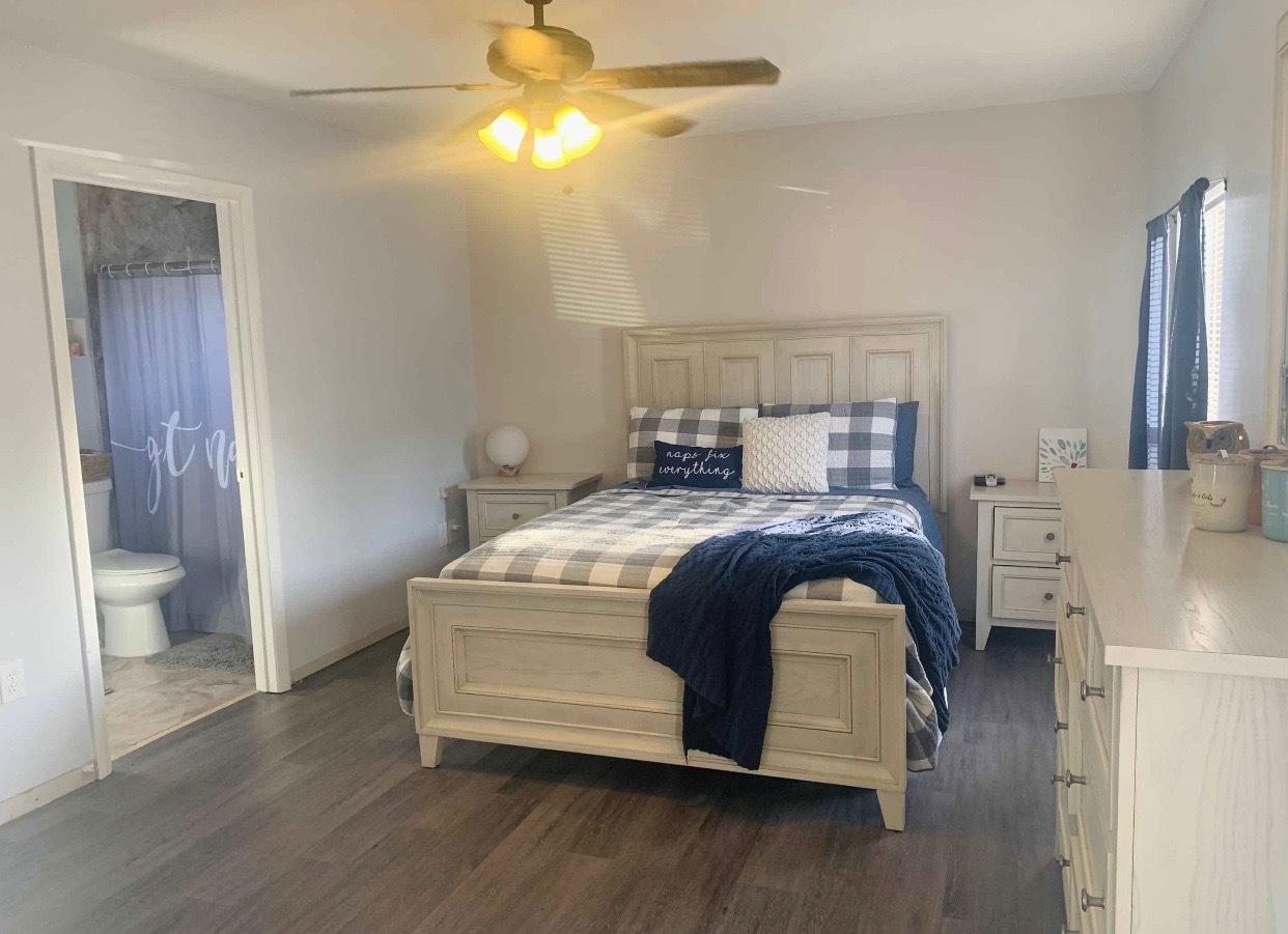 680 Southwest 17th Court Boca Raton, FL 33486 - Photo 10 of 27 a bedroom with a bed and a chandelier