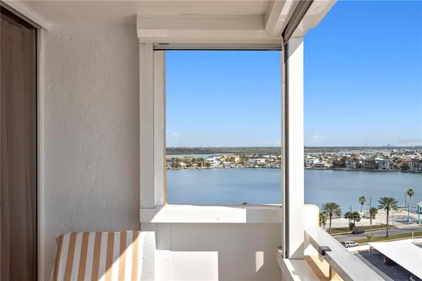 a view of a balcony with table and chairs