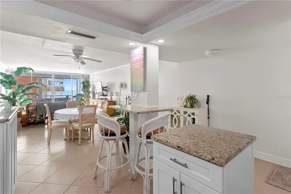 a kitchen with a table chairs and white cabinets