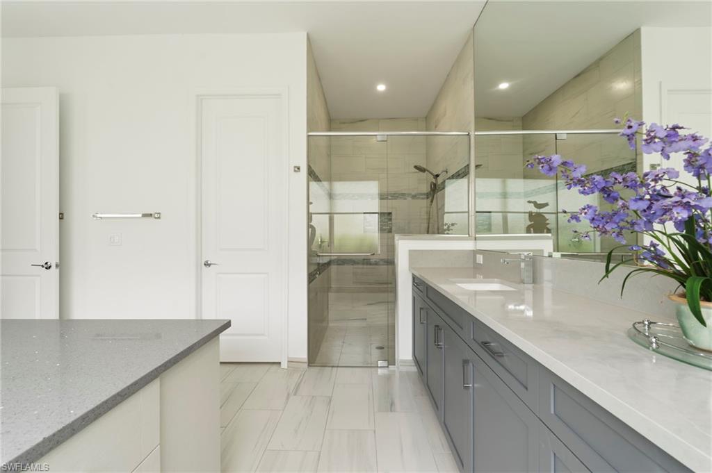 12083 Azalea Way Naples, FL 34120 - Photo 20 of 48 Primary bathroom suite with quartz counters, large walk-in shower, water closet