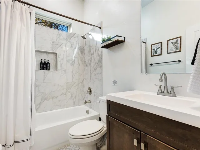 a bathroom with a sink a toilet and a bathtub