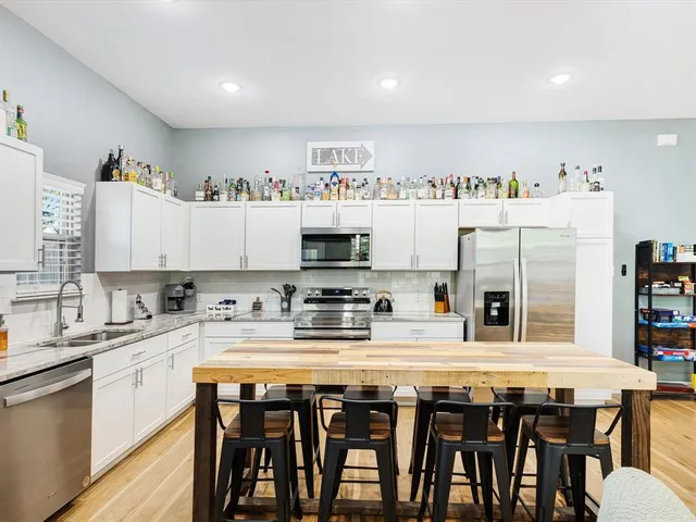 a kitchen with stainless steel appliances granite countertop a sink and cabinets