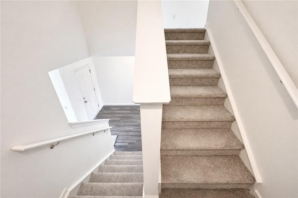 44 Rowlett Place Winder, GA 30680 - Photo 13 of 47 a view of staircase with white walls